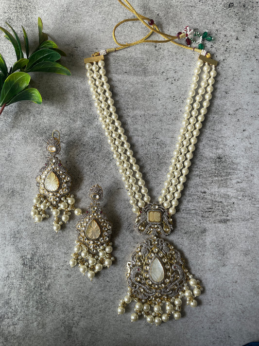 Long Pearl Necklace Paired with Matching Carved Pearl Earrings