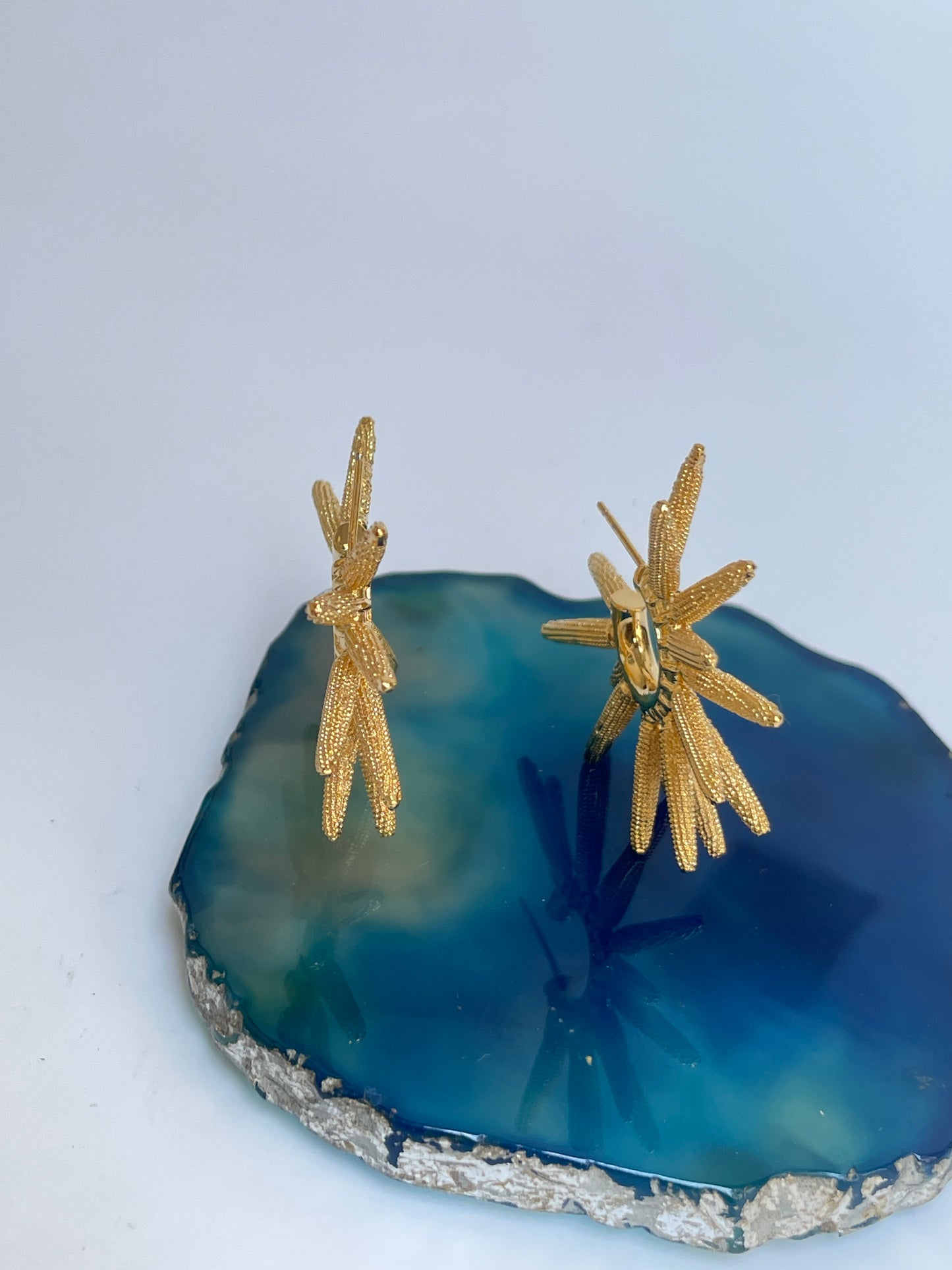 Gold Plated Sun Ray Hoop  Earrings by Studio6jewels on blue stone.