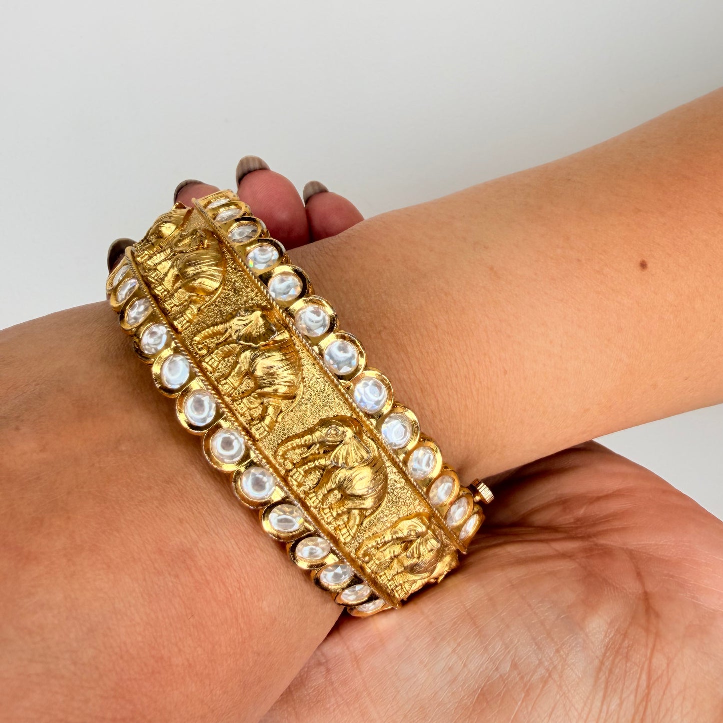 Gold Finish Elephant Carvings Bangle with Kundan Accents