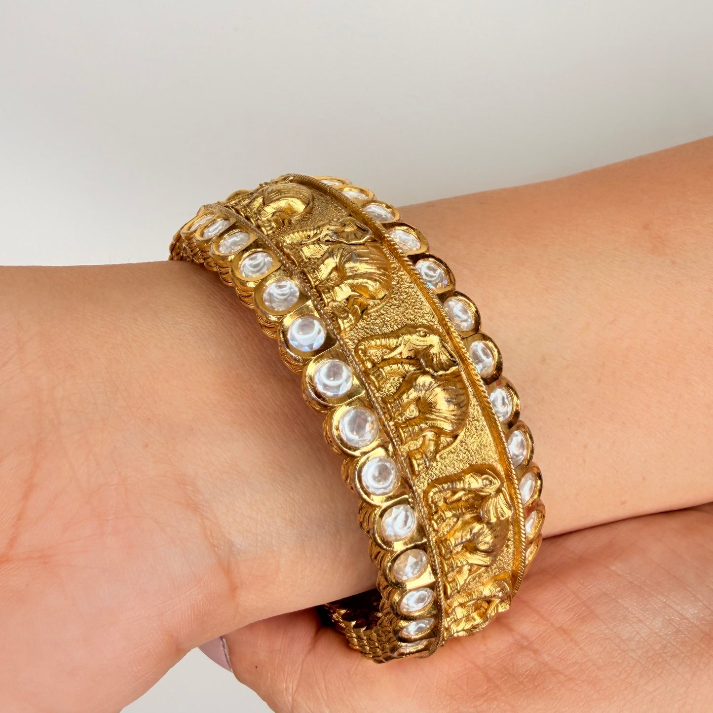 Gold Finish Elephant Carvings Bangle with Kundan Accents