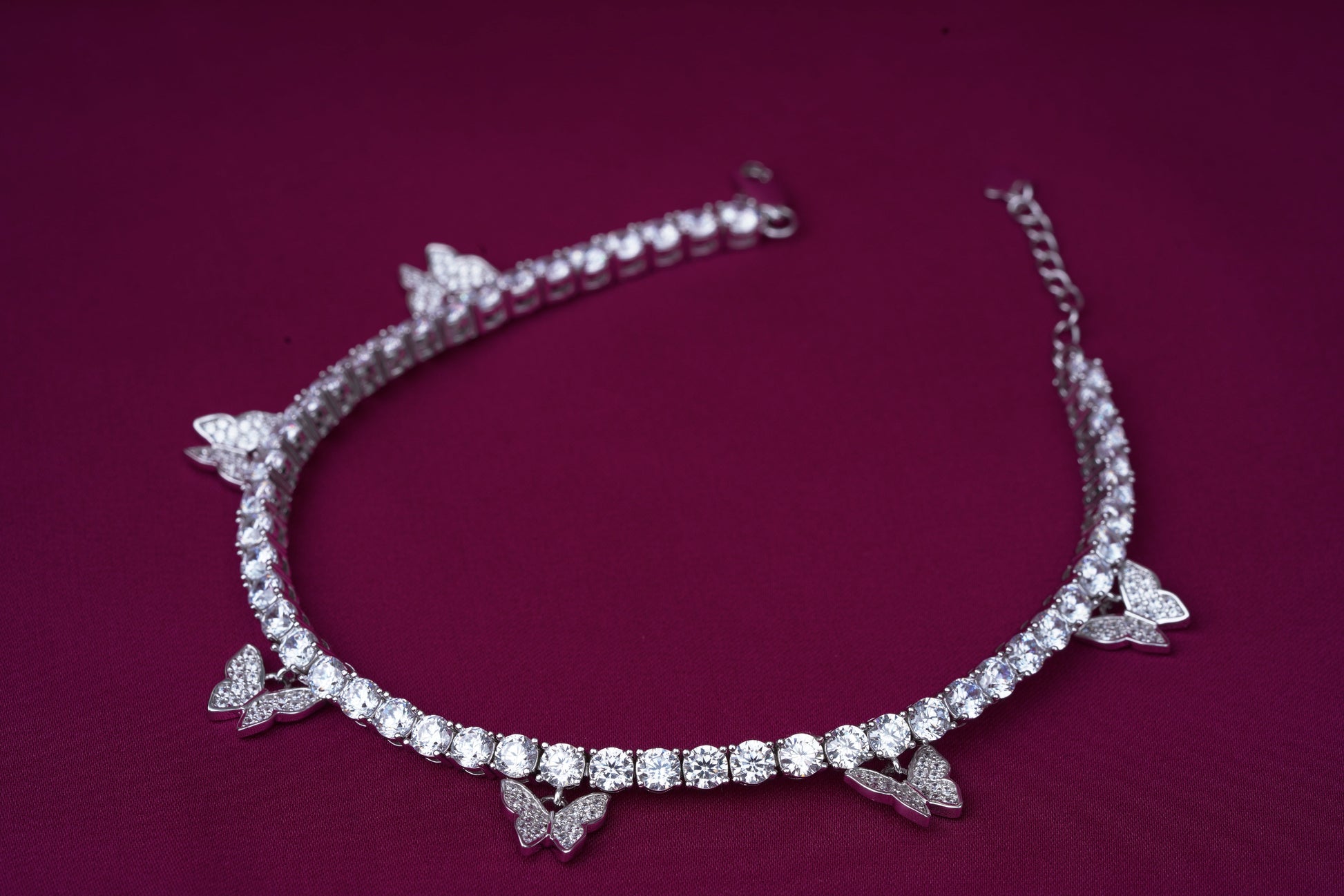 Single line solitaire with hanging butterflies on silver.Studio6Jewels